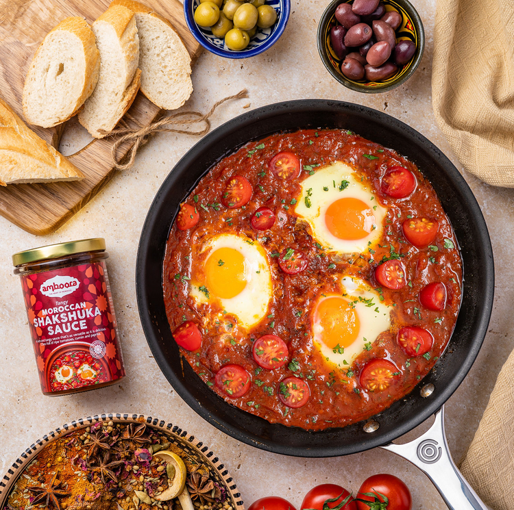 Amboora Moroccan Tagine Cooking Sauce in a jar paired with eggs and tomatoes
