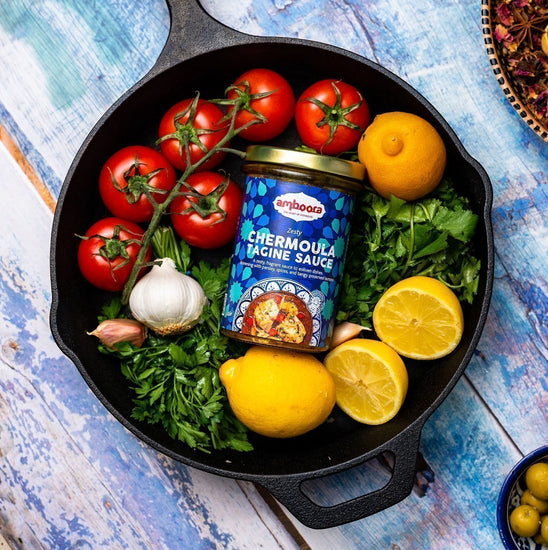 Amboora Moroccan Tagine Cooking Sauce in a jar in a pan surround with ingredients